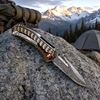 GT-DM021 compact Damascus folding knife with stylish two-tone G10 handle, smooth ball bearing pivot & 59-60HRC sharp blade. 110g lightweight mini EDC knife for daily carry, camping & collection, retail black gift box included.